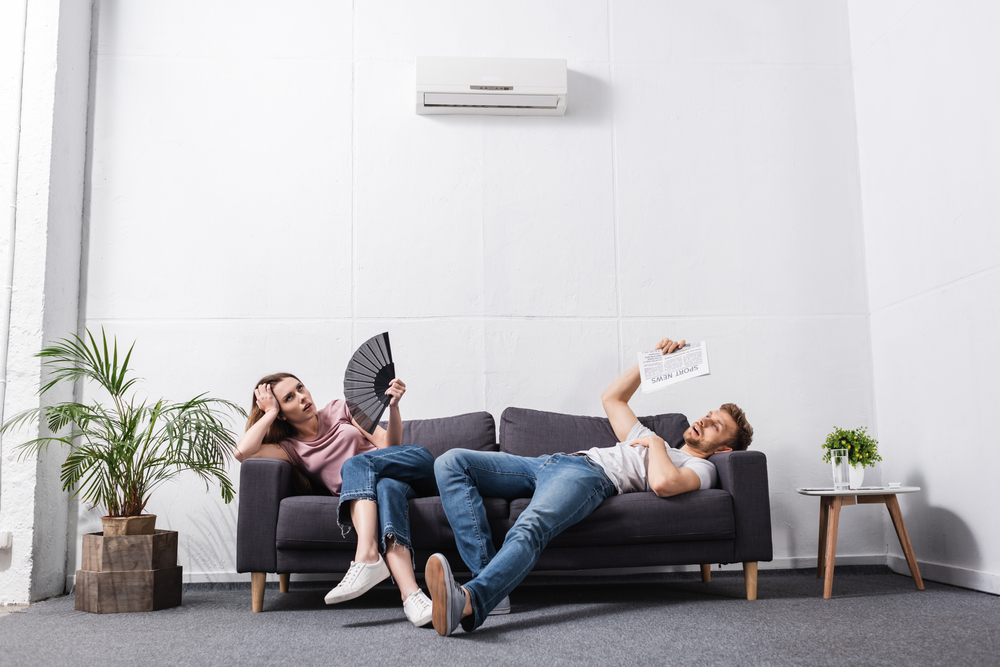 Young Couple Suffering from Heat at Home